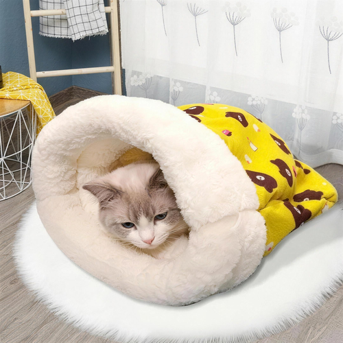 Cat curled up inside the yellow Cozy Cat Sleeping Bag on a fluffy white rug