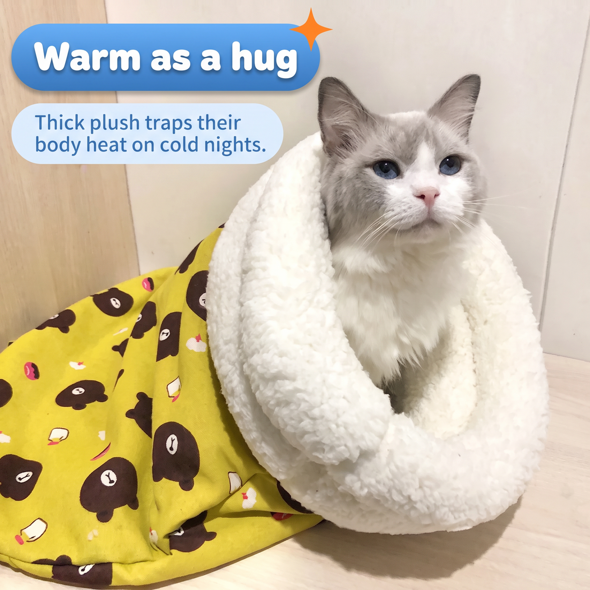Warm as a hug: cat sitting inside the thick plush cuff of the yellow sleeping bag